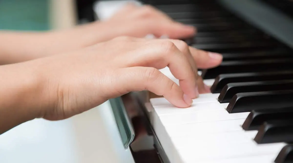 Close up of woman hands playing piano